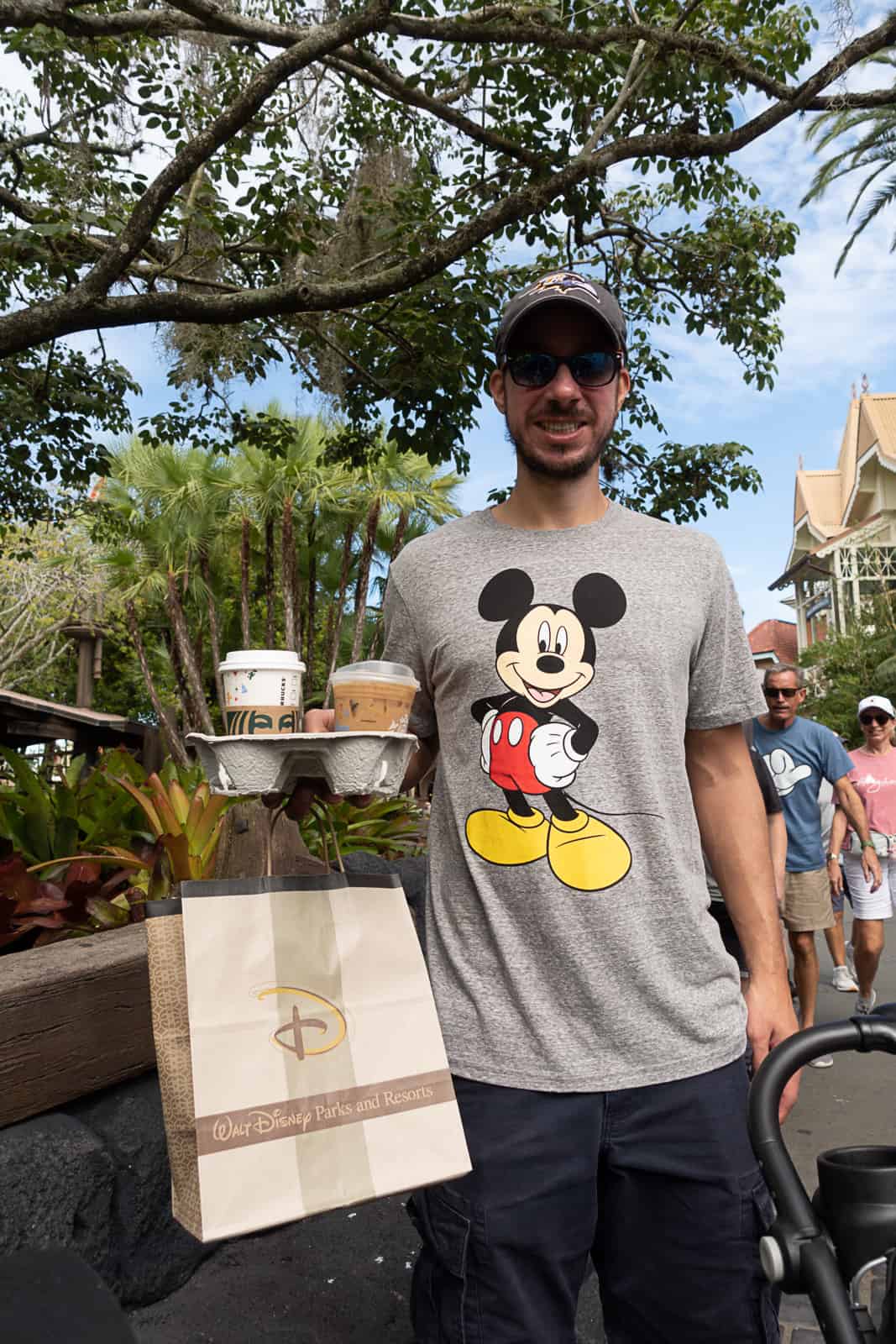 Disney World Travel Blogger holding Joffreys coffee and merchandise bag