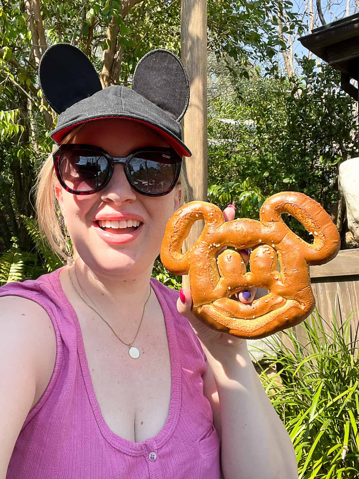 Disney World Travel Enthusiast Jenna Passaro holding a Mickey Pretzel