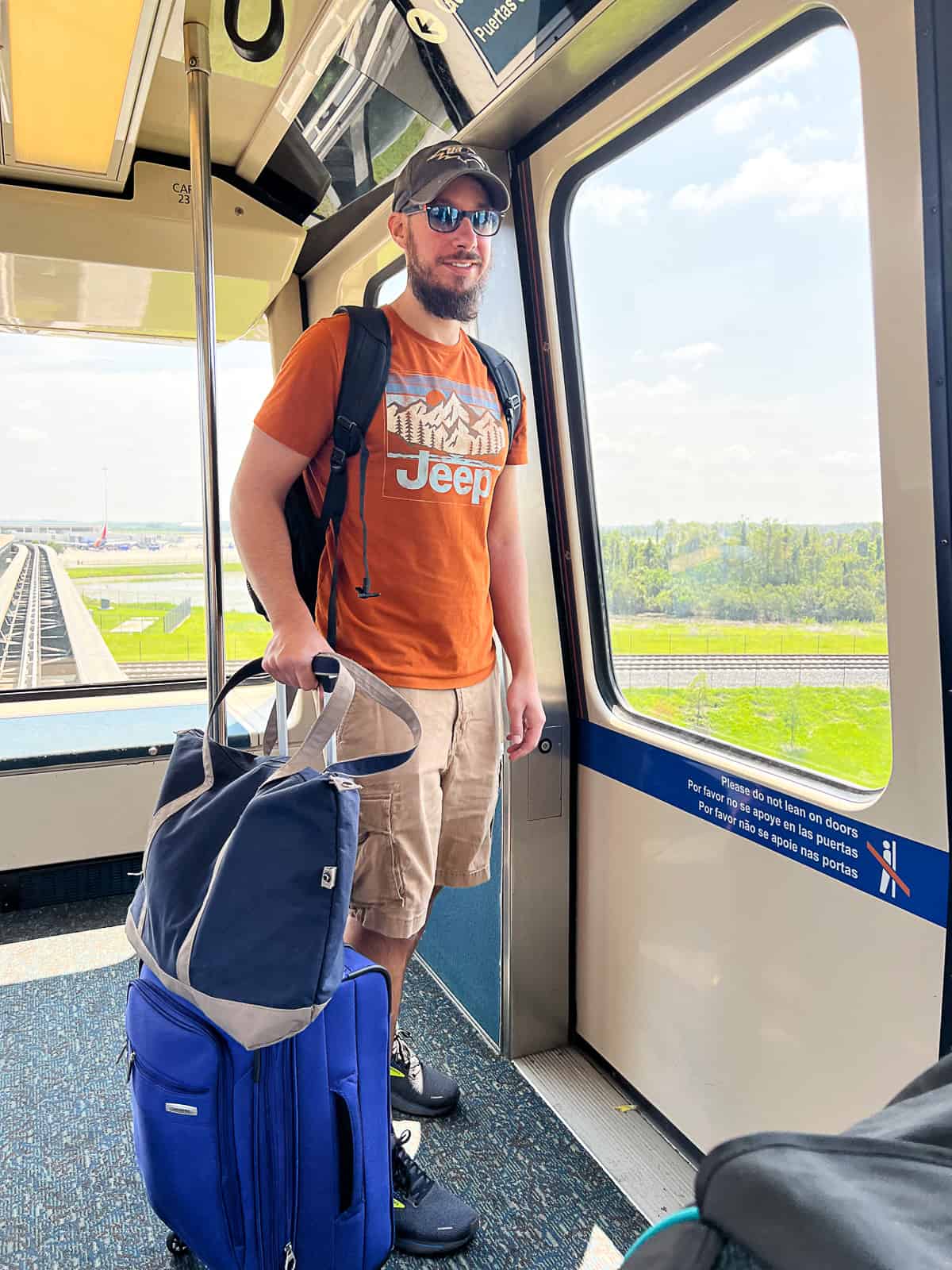 Disney World tourist taking tram from arrivals to baggage claim at MCO Airport
