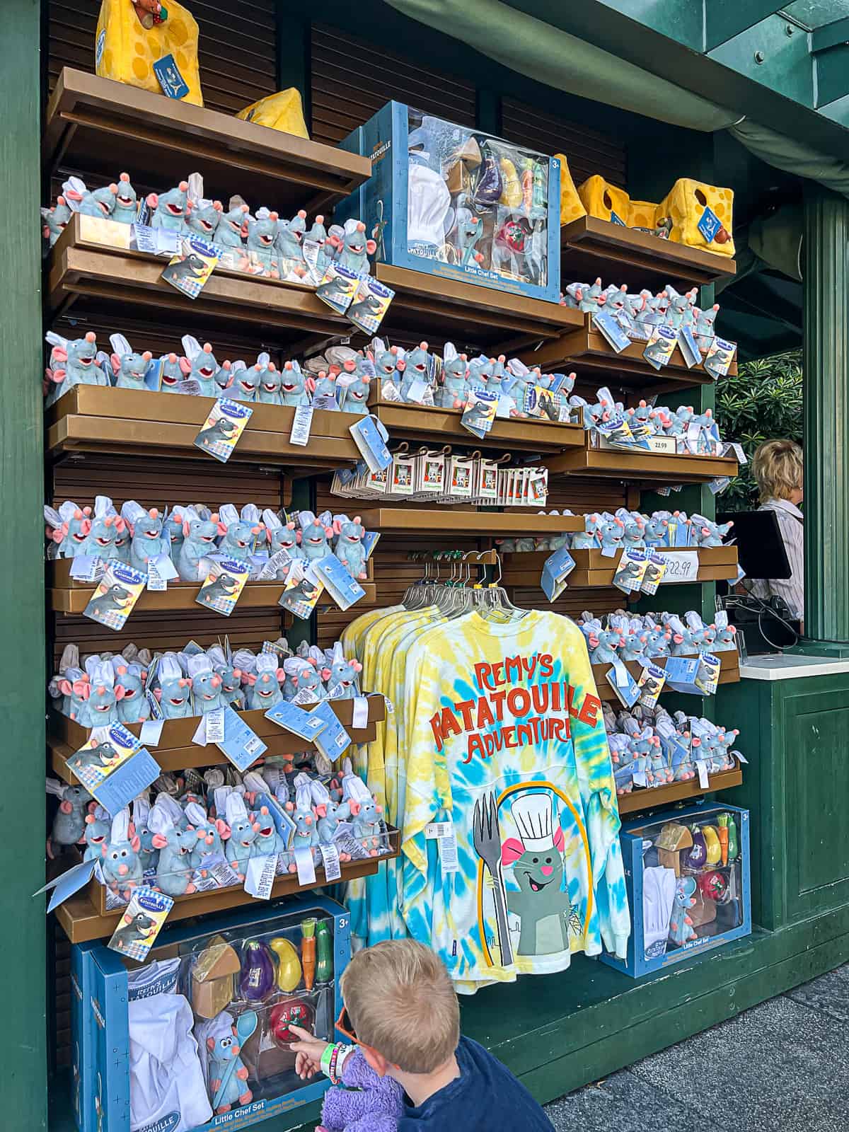 Kid at Remy's Ratatouille gift kiosk in Disney World Epcot Park