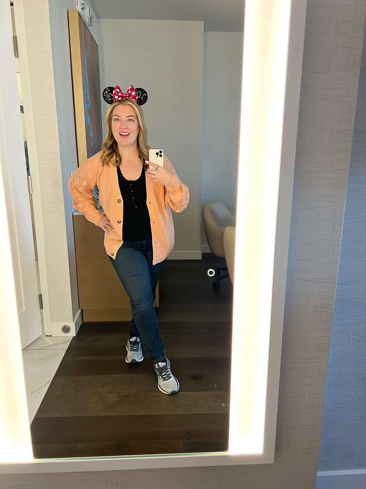Disney Blogger Jenna Passaro wearing Disney outfit for women with Oversized sweater in Disneyland in December