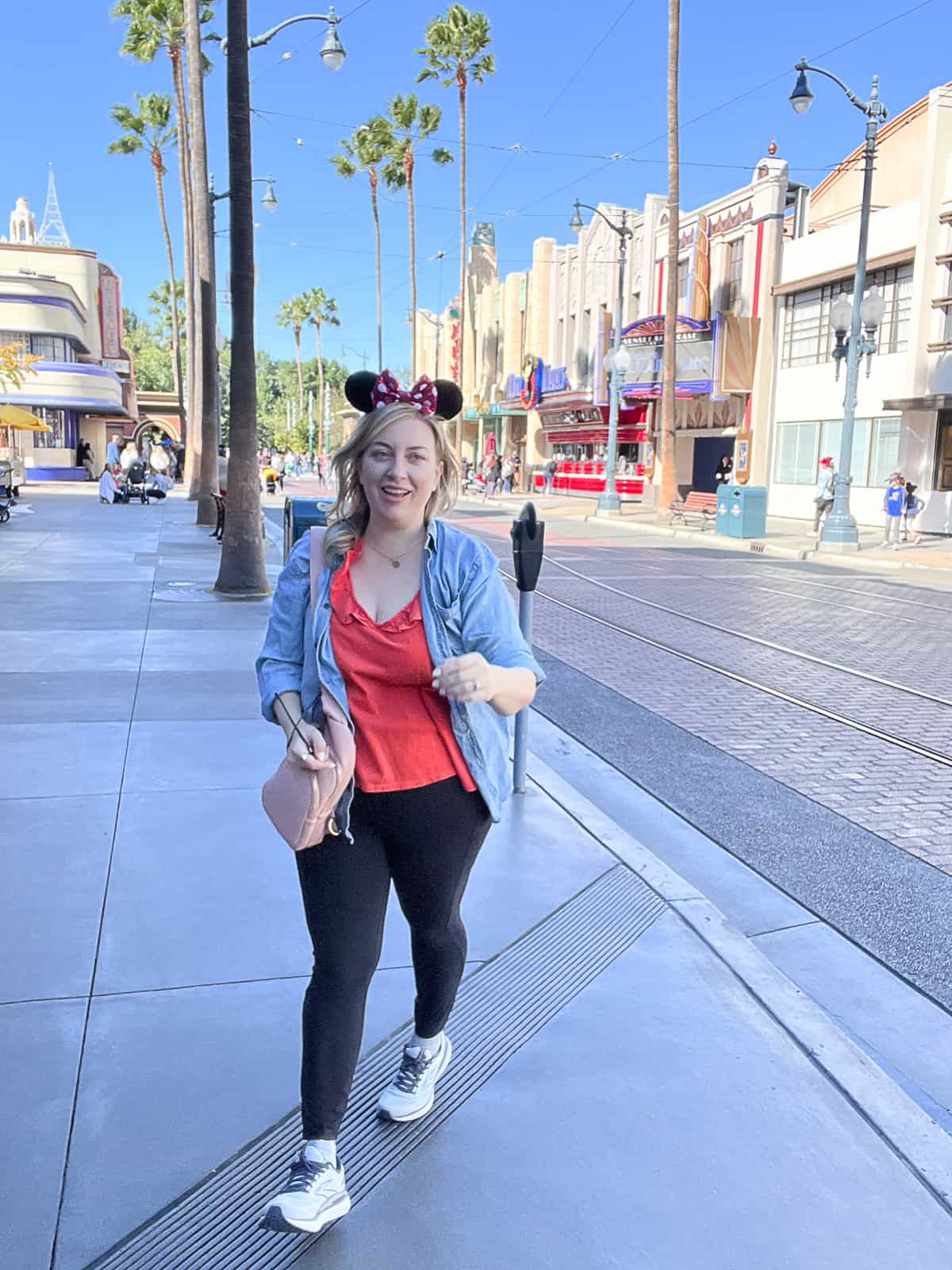 Disney Blogger Jenna Passaro wearing cute Disney outfit for women with leggings and jean jacket