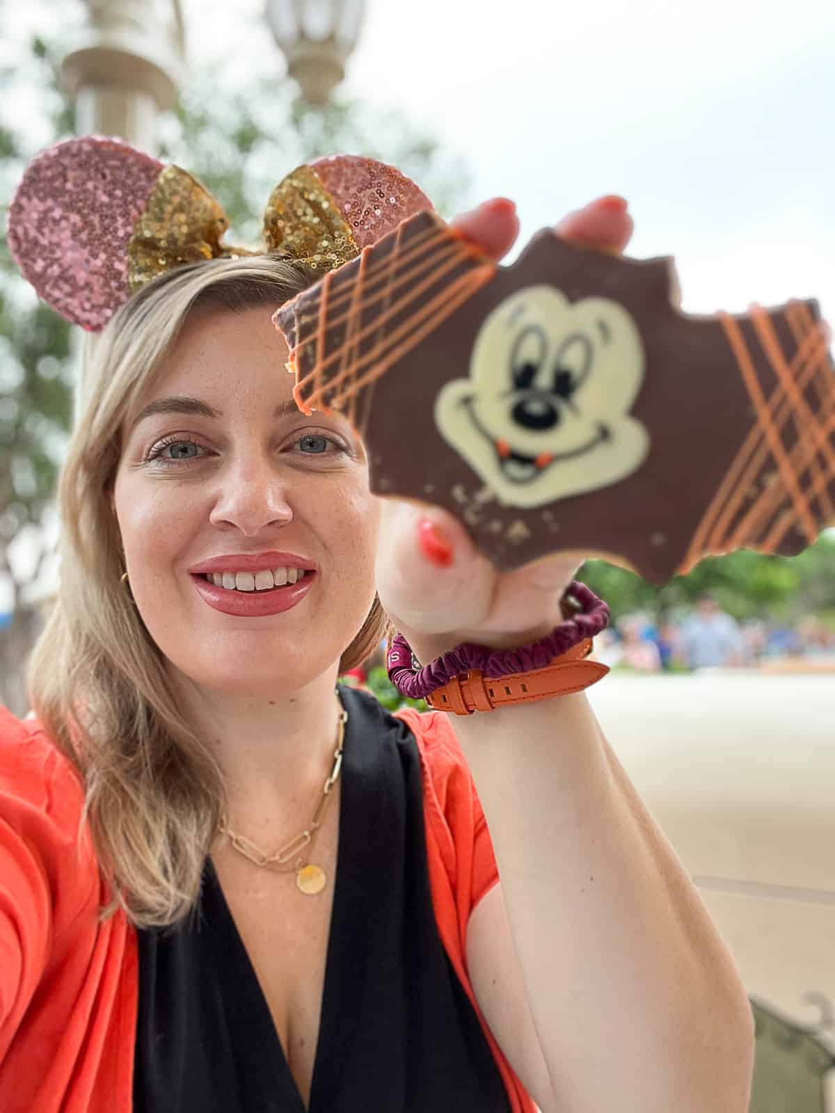 Disneyland Food Blogger holding Bat Mickey Shaped Halloween sugar cookies