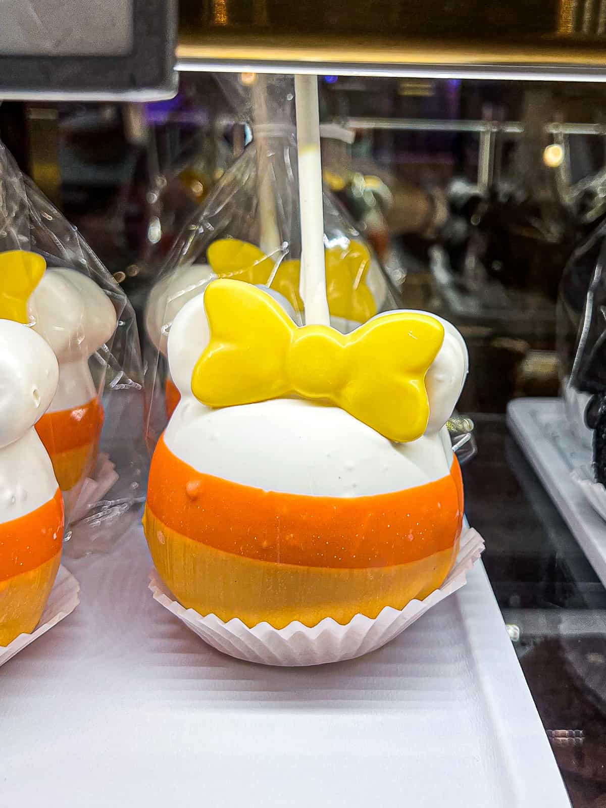 Halloween Time Caramel Apple in Candy Corn Coating with Minnie ears at Disneyland California