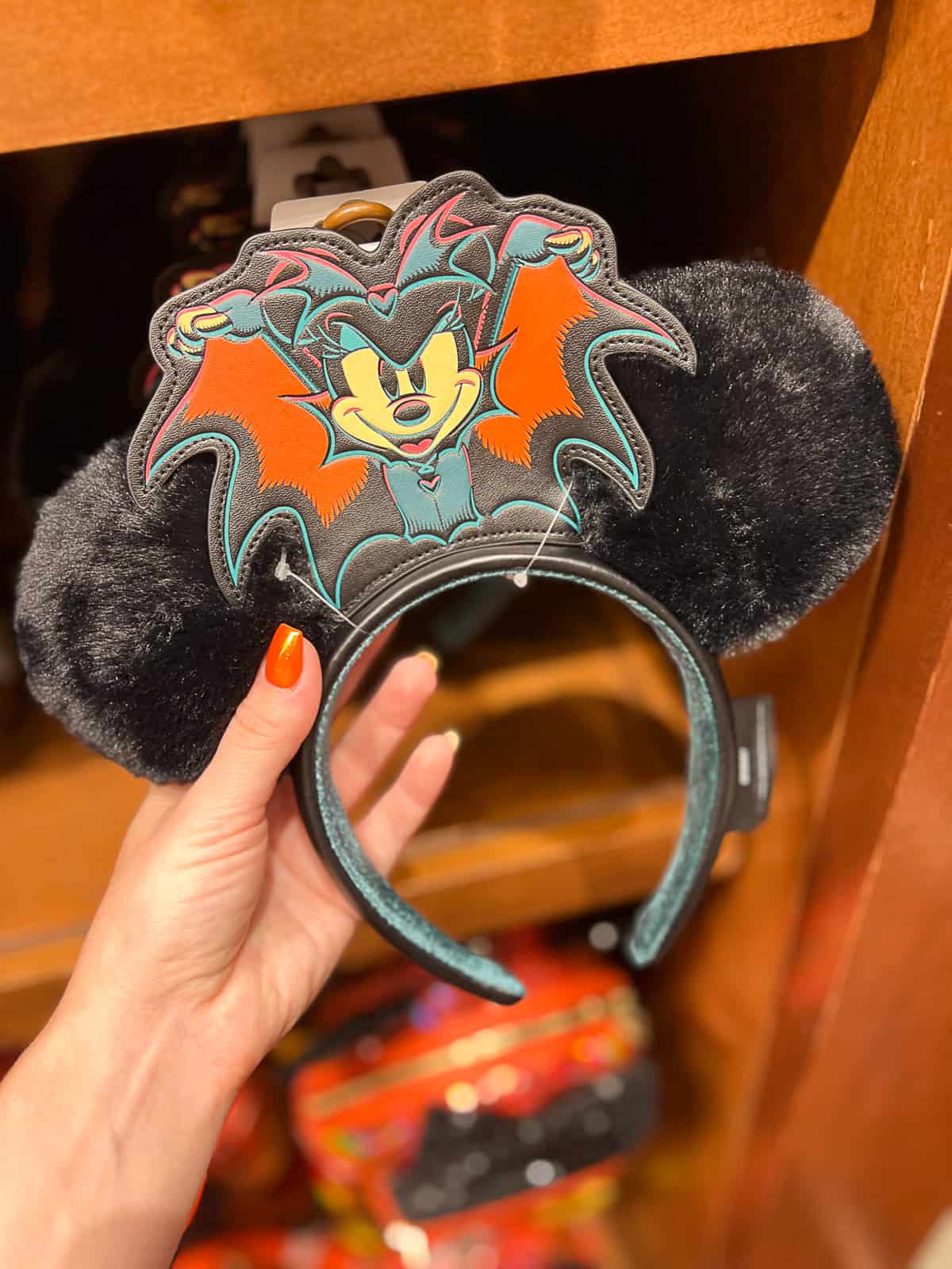 Holding Halloween Mickey ears in Disneyland