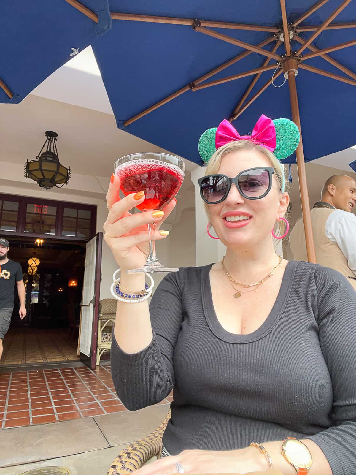 Jenna Passaro Disneyland Food Blogger holding Poison Apple Martini served during Halloween at Disneyland